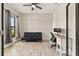 Bright home office features a ceiling fan, a comfortable sofa, and a large window with natural light at 12617 Oak Hill Way, Parrish, FL 34219