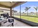 Relaxing screened-in patio area with comfortable seating, overlooking a spacious fenced backyard at 12617 Oak Hill Way, Parrish, FL 34219