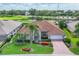 Beautiful aerial view of home showing the tile roof, landscaping, and golf course community at 1345 Reserve Dr, Venice, FL 34285