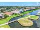 Aerial view of a residential area with waterfront homes, lakes, and green landscaping at 1345 Reserve Dr, Venice, FL 34285