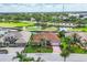 Beautiful aerial view of home showing the tile roof, landscaping, and golf course community at 1345 Reserve Dr, Venice, FL 34285