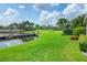 Lush backyard with a pond, a bridge, and meticulously maintained landscaping at 1345 Reserve Dr, Venice, FL 34285