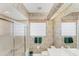 Bathroom featuring floral wallpaper, enclosed shower, and large mirror at 1345 Reserve Dr, Venice, FL 34285