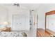 White bedroom with double closet doors and decorative ceiling fan at 1345 Reserve Dr, Venice, FL 34285