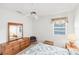 Bright bedroom with white walls, window with blinds, and wooden dresser at 1345 Reserve Dr, Venice, FL 34285