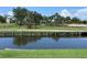Scenery featuring a waterway surrounded by grass, trees, and a gazebo in a charming community setting at 1345 Reserve Dr, Venice, FL 34285