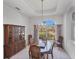 Dining room with a chandelier, a hutch, and views of the landscaped yard at 1345 Reserve Dr, Venice, FL 34285