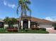 Charming single-story home featuring a tile roof, well-manicured lawn, and lush landscaping at 1345 Reserve Dr, Venice, FL 34285