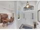 Foyer view with chandelier and front door, adjacent to the dining area at 1345 Reserve Dr, Venice, FL 34285