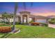 Charming single-story home featuring a tile roof, manicured landscaping, and a welcoming front entrance at 1345 Reserve Dr, Venice, FL 34285