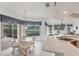 Bright kitchen with a glass table, tiled floors, and large windows overlooking the backyard and the golf course at 1345 Reserve Dr, Venice, FL 34285