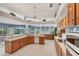 Bright and open kitchen features tile floors, a breakfast bar, lots of cabinets and scenic backyard views at 1345 Reserve Dr, Venice, FL 34285
