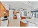 Spacious kitchen featuring oak cabinets, white appliances, tile floors and large island at 1345 Reserve Dr, Venice, FL 34285