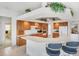 Bright kitchen with oak cabinets, tile floors, white countertops, and breakfast bar seating at 1345 Reserve Dr, Venice, FL 34285