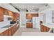 Bright kitchen featuring oak cabinets, white appliances, tile floors and large island at 1345 Reserve Dr, Venice, FL 34285