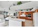 Bright kitchen with oak cabinets, tile floors, white countertops, and breakfast bar seating at 1345 Reserve Dr, Venice, FL 34285