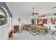 Bright living room featuring a leather couch, glass tables, and view into kitchen at 1345 Reserve Dr, Venice, FL 34285