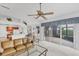 Open-concept living room with combined kitchen, a ceiling fan, and sliding glass doors to the patio at 1345 Reserve Dr, Venice, FL 34285