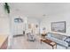Bright living room featuring white walls, tile floors, and classic furnishings at 1345 Reserve Dr, Venice, FL 34285