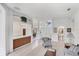 Open-concept living room with tiled floors and views of the entry and bathroom at 1345 Reserve Dr, Venice, FL 34285