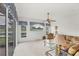 Living room with large windows offering views of the canal and landscaped yard at 1345 Reserve Dr, Venice, FL 34285