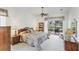 Main bedroom featuring a ceiling fan, a bookcase, and patio access overlooking the water at 1345 Reserve Dr, Venice, FL 34285