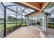 Screened-in patio with tan tile flooring and view of the water at 1345 Reserve Dr, Venice, FL 34285