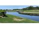 Picturesque water view featuring a bridge and golf course landscape creating a tranquil setting at 1345 Reserve Dr, Venice, FL 34285