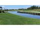 Scenic water view with a wooden bridge and lush green landscaping in a serene golf course setting at 1345 Reserve Dr, Venice, FL 34285
