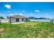 Spacious backyard featuring a well-maintained lawn and white fence at 137 Hercules Dr, Rotonda West, FL 33947