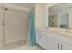 Bathroom featuring a walk-in shower, double sinks, and modern fixtures at 137 Hercules Dr, Rotonda West, FL 33947