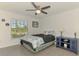 Cozy bedroom with a comfortable bed, side table, and a large window at 137 Hercules Dr, Rotonda West, FL 33947