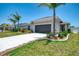 Well-maintained single-Gathering home with a two-car garage and lush landscaping at 137 Hercules Dr, Rotonda West, FL 33947