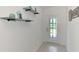 Hallway featuring decorative shelving and a door with decorative glass at 137 Hercules Dr, Rotonda West, FL 33947