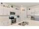 Bright kitchen featuring white cabinets, stainless steel appliances, and a quartz countertop at 137 Hercules Dr, Rotonda West, FL 33947