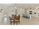 Open floor plan featuring kitchen with a white island, updated appliances, and adjacent dining area at 137 Hercules Dr, Rotonda West, FL 33947