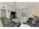 Cozy living room featuring tile floors, a ceiling fan, and sliding glass doors to the backyard at 137 Hercules Dr, Rotonda West, FL 33947