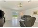 Cozy living room featuring tile floors, a ceiling fan, and sliding glass doors to the backyard at 137 Hercules Dr, Rotonda West, FL 33947