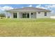 Expansive backyard featuring a covered patio and ample green space at 137 Mariner Ln, Rotonda West, FL 33947