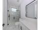 Modern bathroom featuring marble-style tile, glass shower door, and a sleek vanity at 137 Mariner Ln, Rotonda West, FL 33947