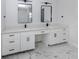 Elegant bathroom with double sinks, marble flooring, and modern black fixtures at 137 Mariner Ln, Rotonda West, FL 33947