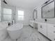 Spa-like bathroom features a soaking tub, double vanity, and sleek, modern fixtures at 137 Mariner Ln, Rotonda West, FL 33947