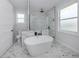 Bright bathroom with soaking tub, glass shower, and clean, modern design at 137 Mariner Ln, Rotonda West, FL 33947