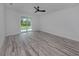 Bedroom featuring sliding doors, wood-style flooring, and neutral color scheme at 137 Mariner Ln, Rotonda West, FL 33947