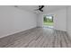 Bedroom featuring wood floors, a ceiling fan, and sliding glass door at 137 Mariner Ln, Rotonda West, FL 33947