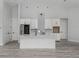 Modern kitchen with stainless steel appliances, white cabinets, and a large island at 137 Mariner Ln, Rotonda West, FL 33947