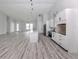 Open-concept living room with a modern kitchen, wood floors, and plenty of space at 137 Mariner Ln, Rotonda West, FL 33947
