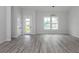 Bright living room with wood floors, a modern light fixture, and ample natural light at 137 Mariner Ln, Rotonda West, FL 33947