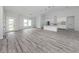 Bright open-concept living room with wood floors and modern lighting at 137 Mariner Ln, Rotonda West, FL 33947