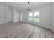Bright living room with wood-style flooring, modern lighting, and large windows at 137 Mariner Ln, Rotonda West, FL 33947